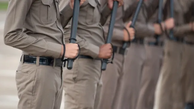 guards holding batons